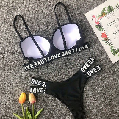 Women's sexy bikini set, black with "LOVE" text, polyester fabric, adult swimwear.