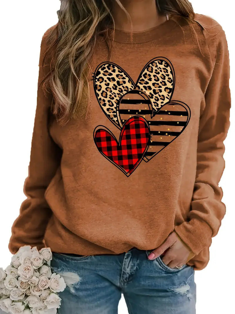 Women's printed long sleeve crew neck sweater in brown with heart designs.