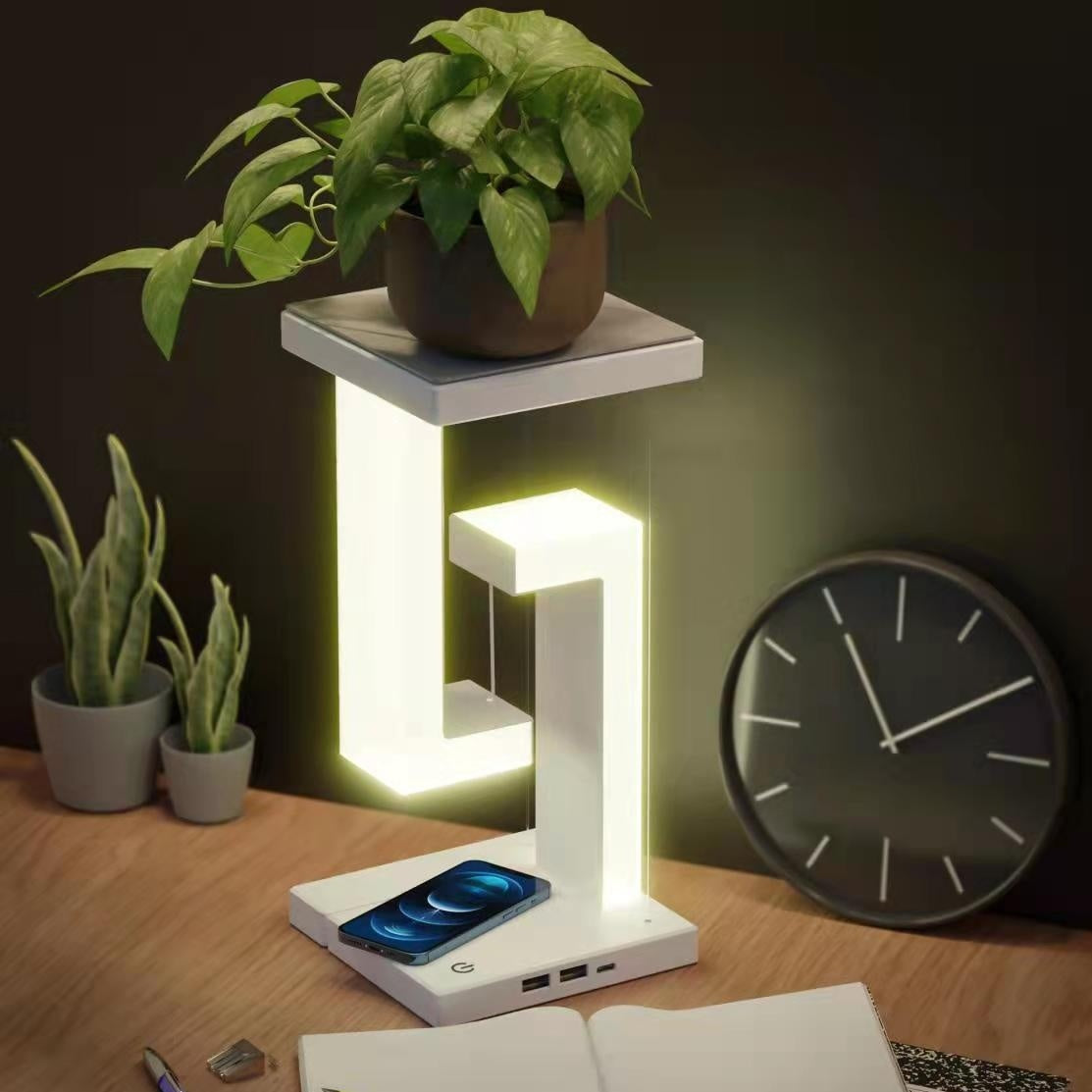 Wireless charging suspension table lamp with plant and clock in modern home setting.
