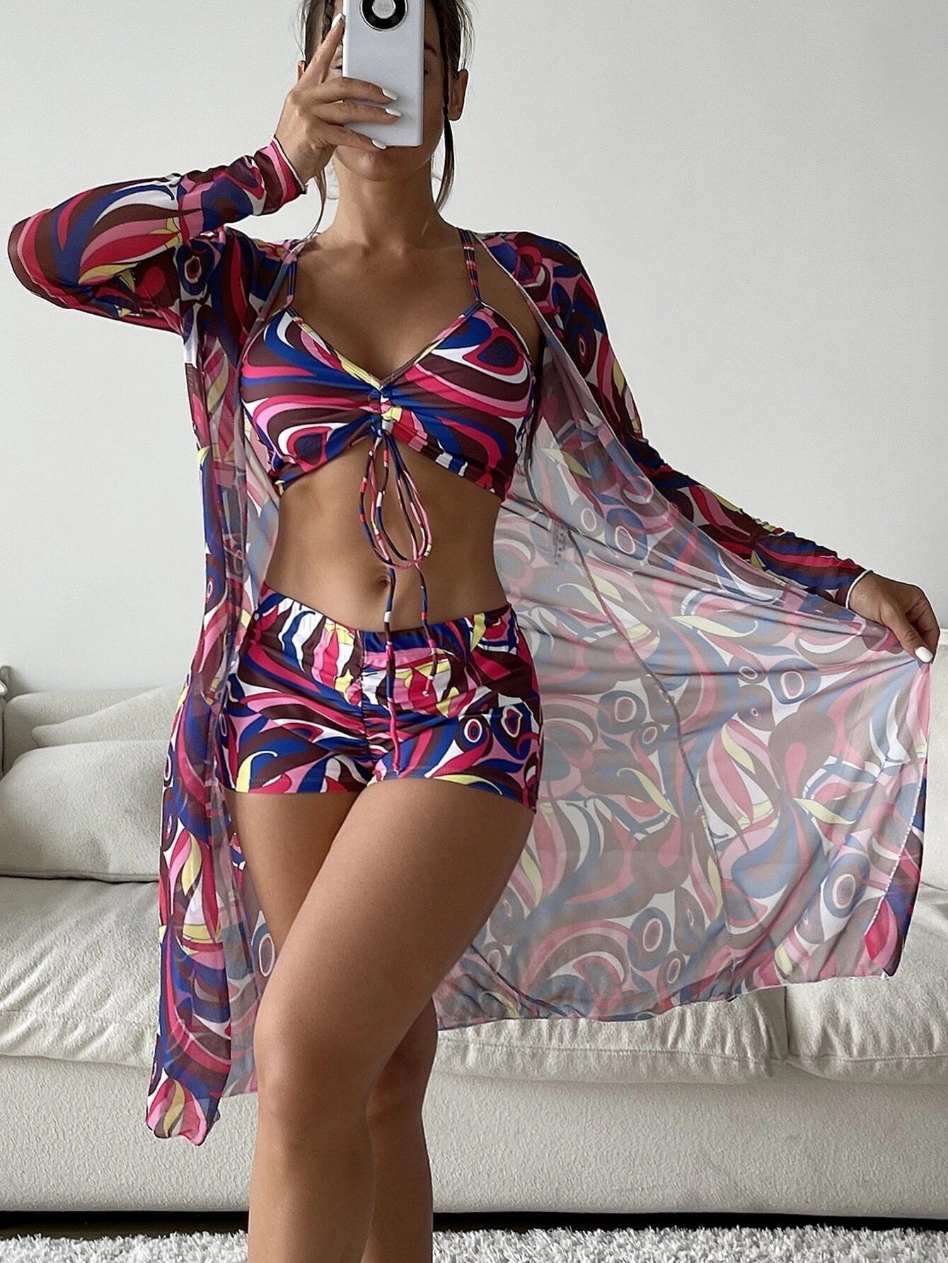 Fashionable 3-piece spring bikini set with long sleeve cardigan in colorful floral pattern, ideal summer beach swimwear for women.