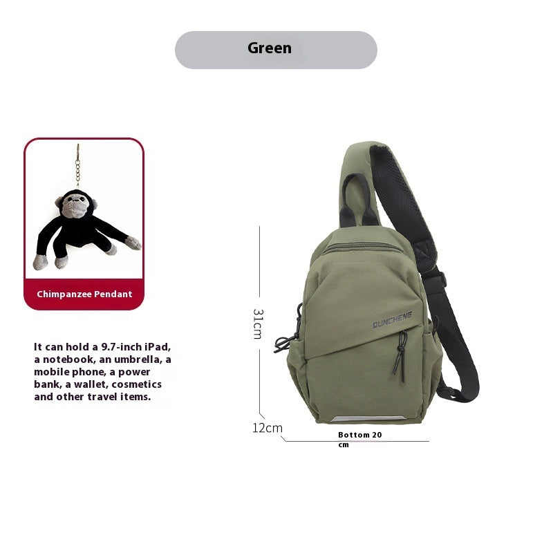 Men's green crossbody bag with black adjustable strap, featuring a chimpanzee pendant, designed for leisure travel.