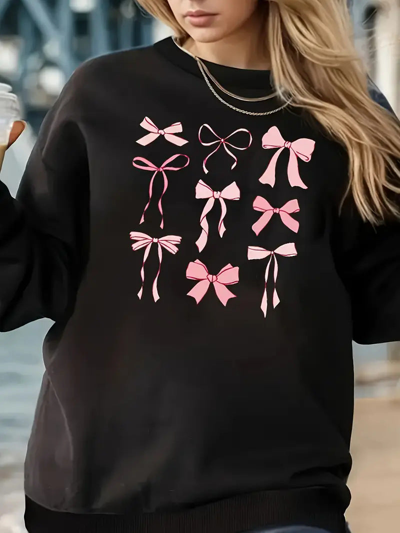 Women's printed long sleeve crew neck sweater with pink bow designs.