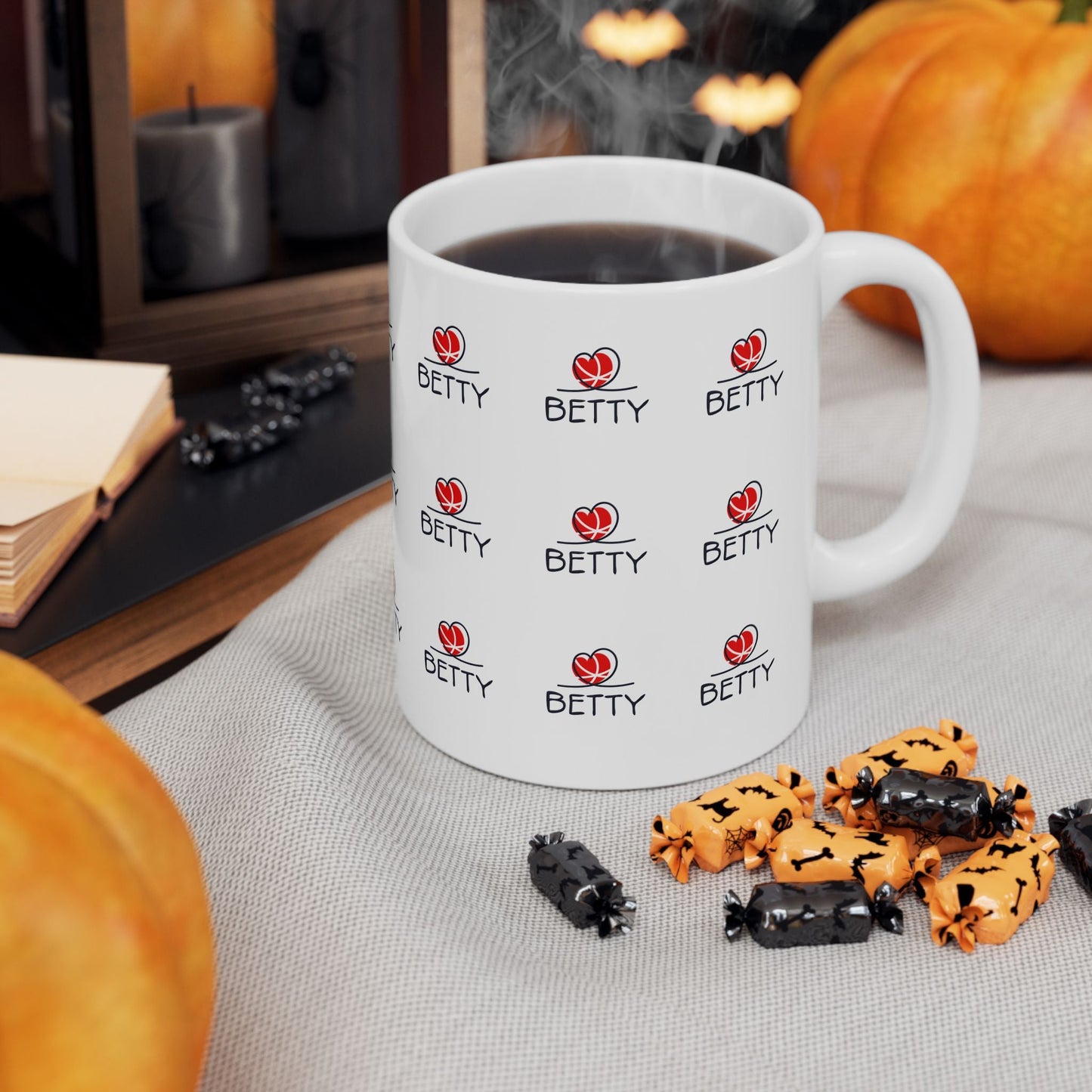 Betty Boop Mug with vibrant colors and glossy ceramic finish on a table with decorative pumpkins.
