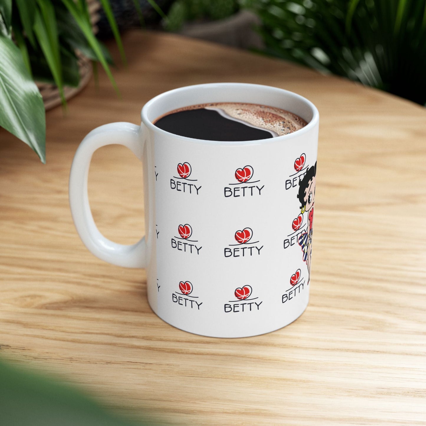 Betty Boop Mug with retro design on a wooden table, featuring glossy ceramic finish and vibrant colors.