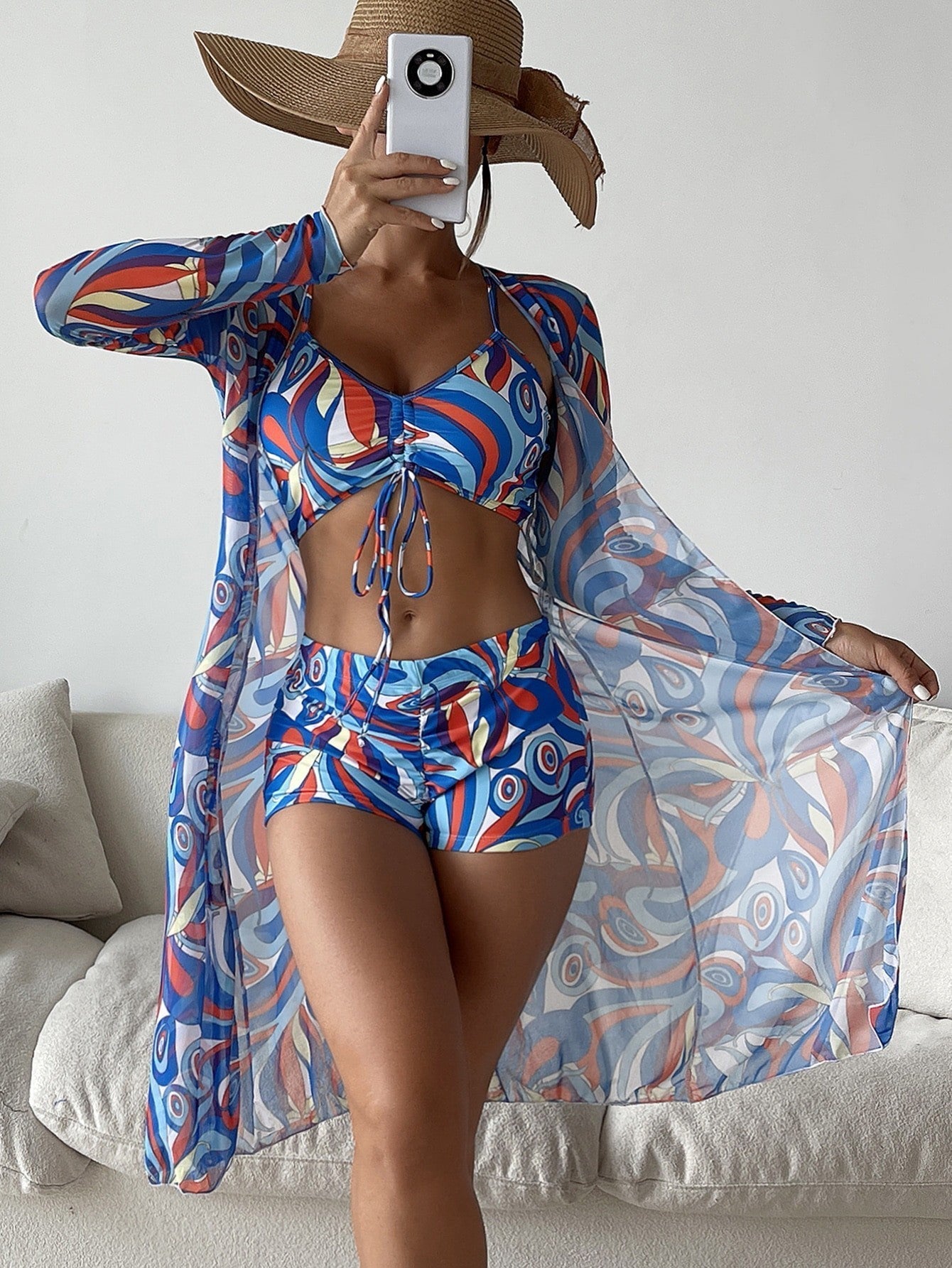 Women’s colorful floral bikini with matching long sleeve cardigan, perfect for summer beachwear.