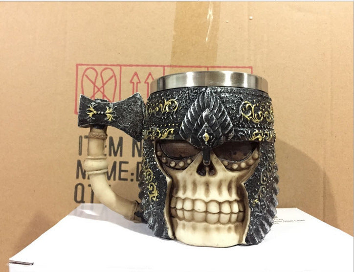 3D skull mug with axe handle, stainless steel and resin design, 400ml capacity.