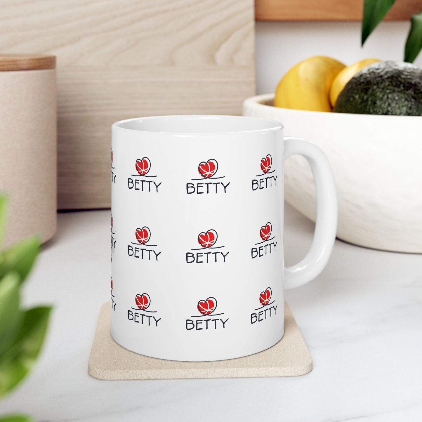 Betty Boop Mug with vibrant design on a white ceramic background, placed on a coaster in a kitchen setting.