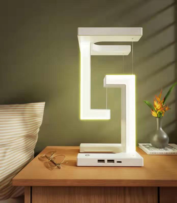 Modern minimalist table lamp with wireless charging and magnetic suspension, ideal for home and office decor.