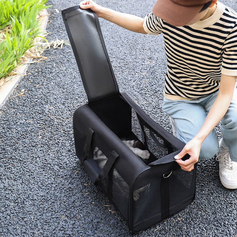 Portable pet carrier bag for dogs and cats, breathable design, ideal for travel.