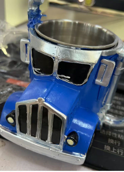 Handcrafted blue semi-truck shaped ceramic coffee mug with a unique resin design, ideal for truck enthusiasts.