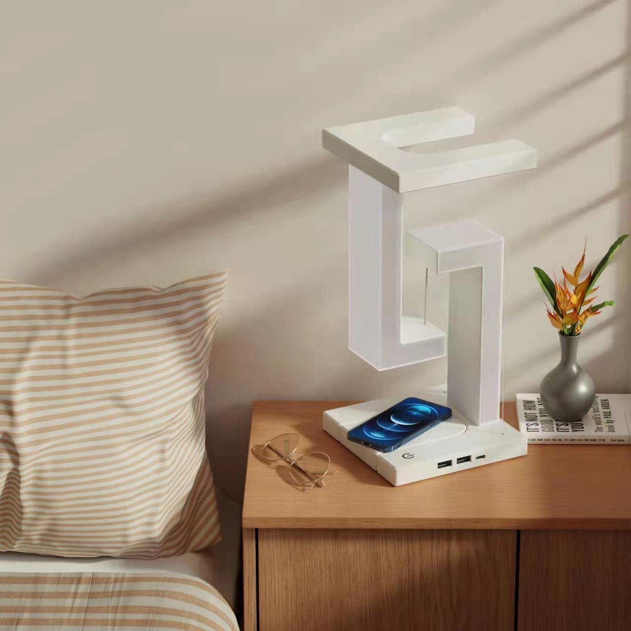 Wireless charging suspension table lamp with magnetic floating design on bedside table.