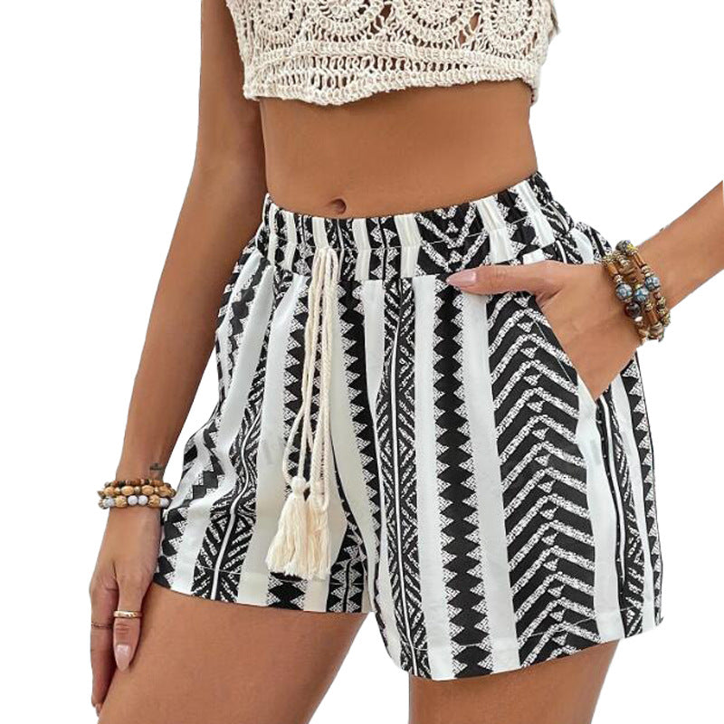 Women's black and white lace-up shorts with elegant pattern and elastic waistband.