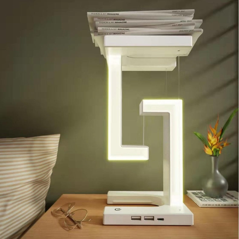Creative smartphone wireless charging table lamp with magnetic suspension, ideal for home and bedroom decor.
