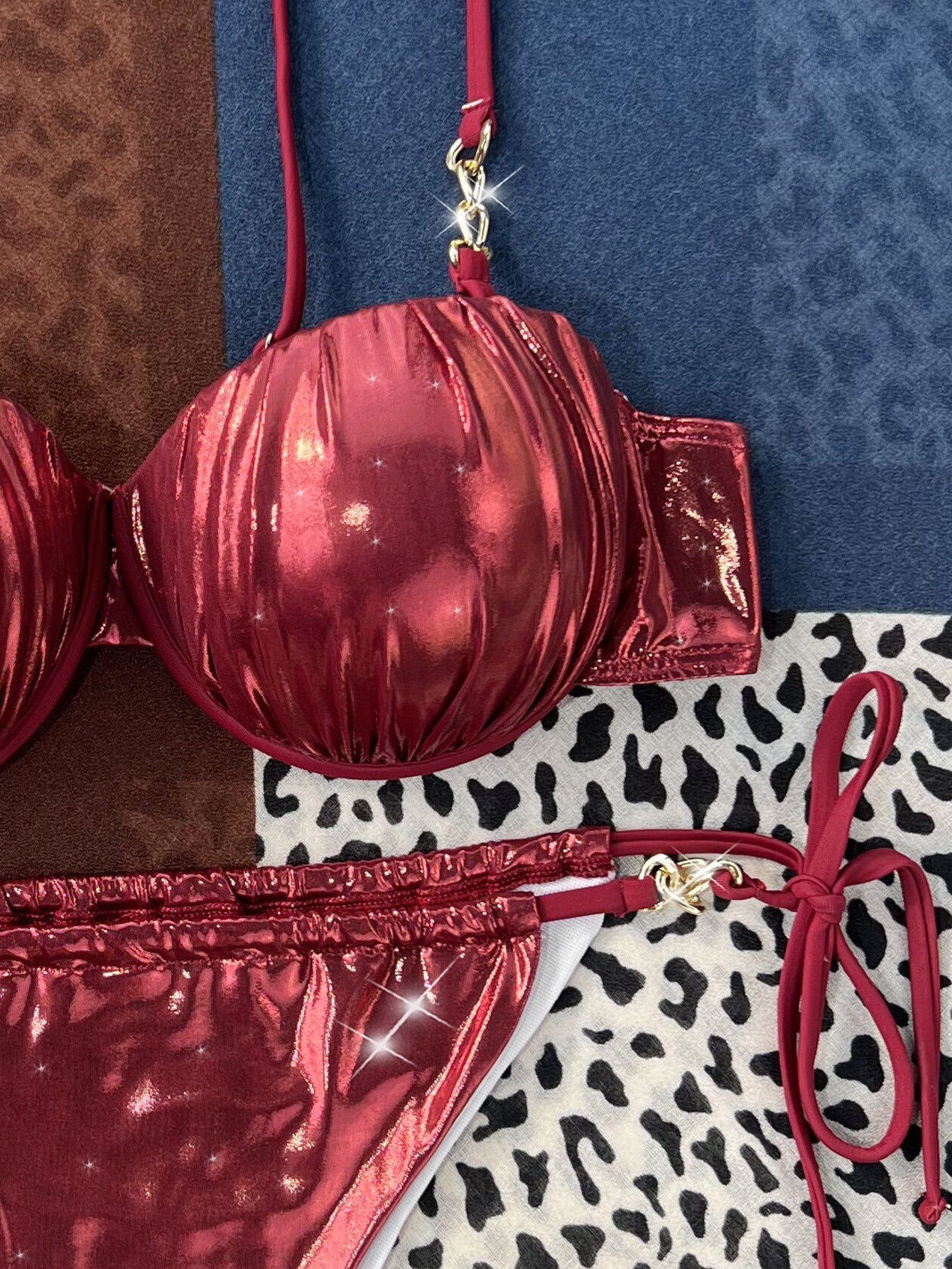 Sexy metallic red bikini with steel bracket and push-up design on patterned background.