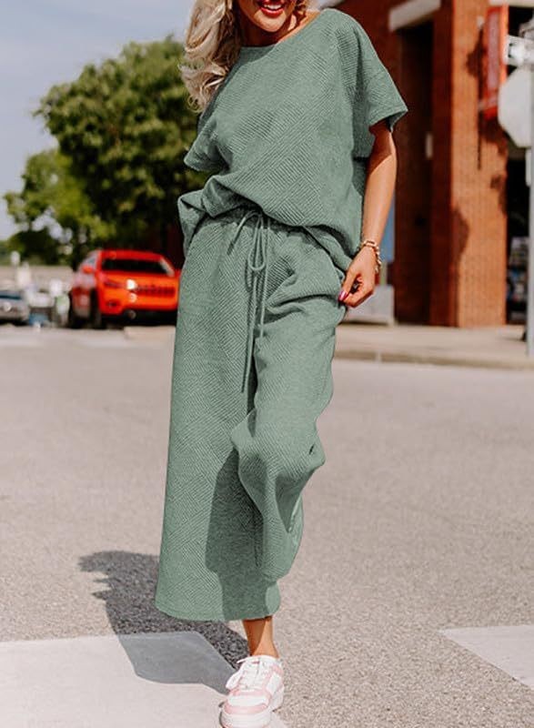 Women's solid color texture two-piece set with short sleeves and trousers, shown in green.