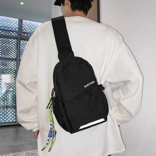 Men's black crossbody bag with letter design, nylon material, ideal for leisure travel.