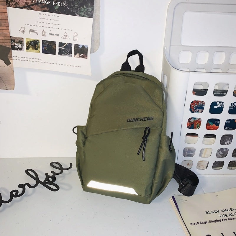 Green nylon crossbody bag with letters, designed for men's leisure travel and street style.