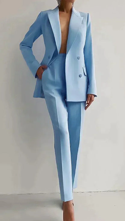 Women's blue casual business suit with long sleeve single-breasted jacket and slim fit trousers.